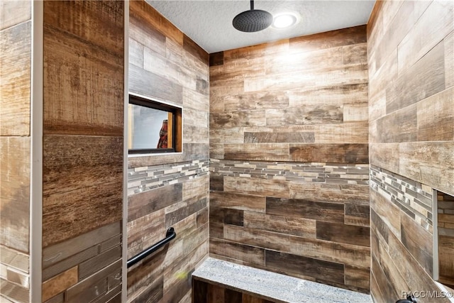 bathroom with a textured ceiling and walk in shower