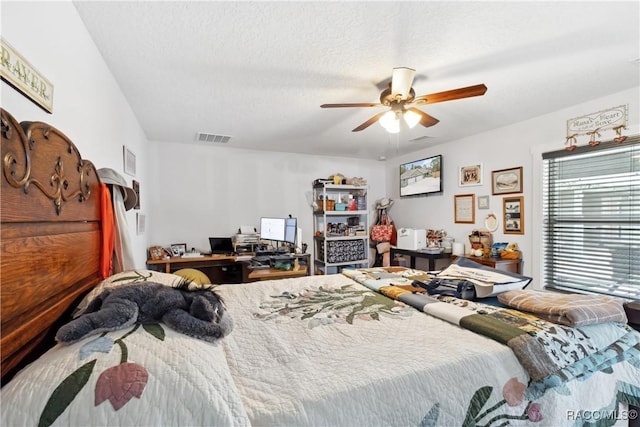 bedroom with a textured ceiling and ceiling fan