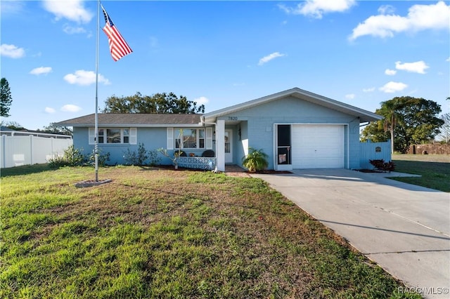 ranch-style house with a front yard, fence, driveway, and an attached garage