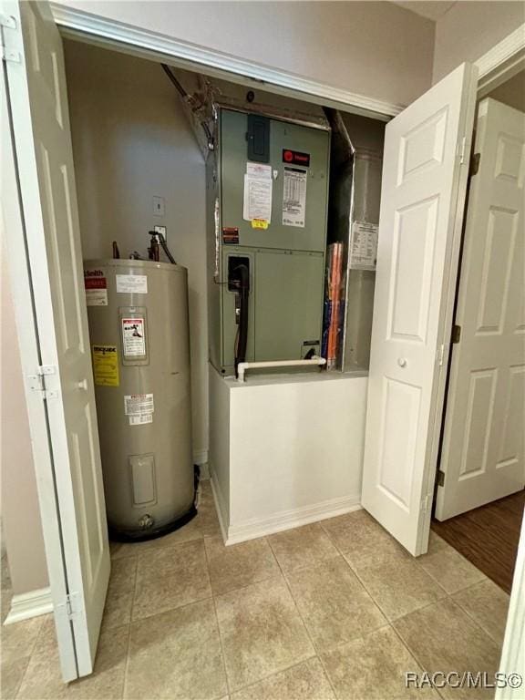 utility room featuring heating unit and water heater