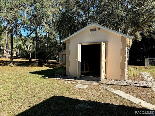 view of outbuilding with a lawn