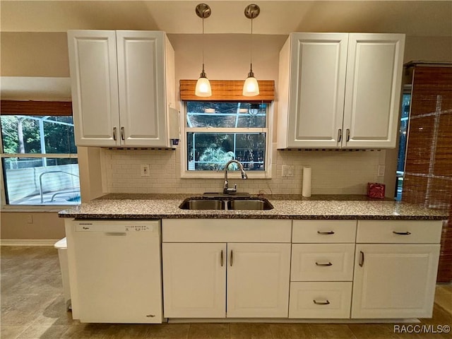 kitchen with pendant lighting, backsplash, white dishwasher, white cabinets, and sink