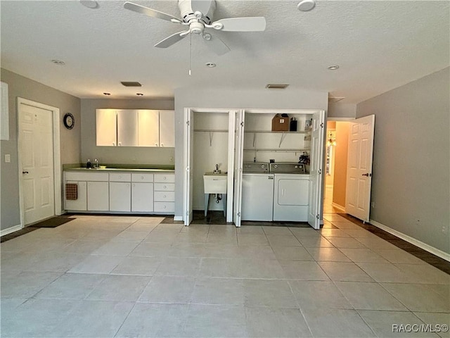 interior space with washer and dryer, light tile patterned floors, ceiling fan, and sink