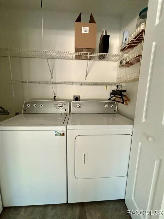 washroom featuring washer and clothes dryer and dark hardwood / wood-style floors