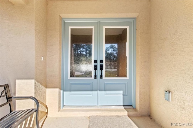 view of exterior entry featuring french doors