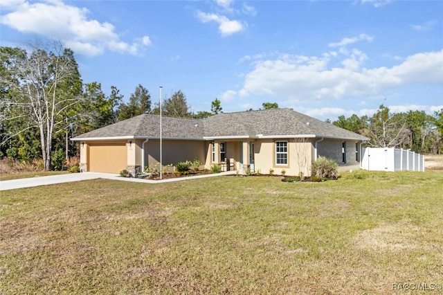 single story home featuring a garage and a front lawn