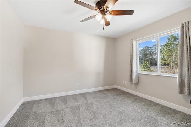 empty room featuring carpet floors and ceiling fan