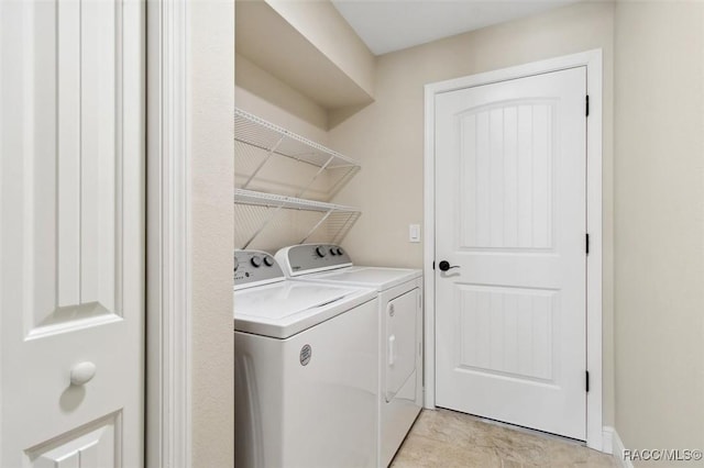 clothes washing area with washer and dryer