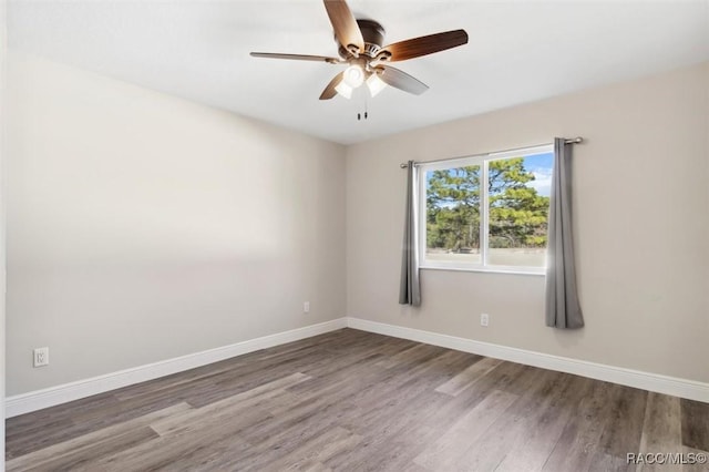 spare room with hardwood / wood-style flooring and ceiling fan