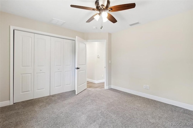 unfurnished bedroom featuring light colored carpet, a closet, and ceiling fan