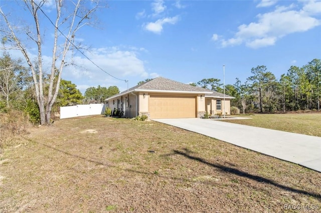 view of front of home with a garage and a front lawn