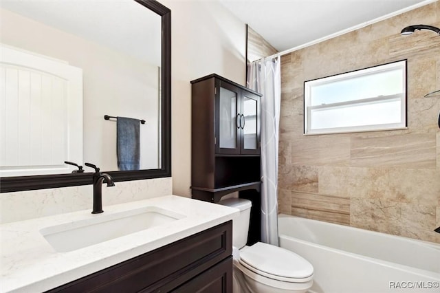 full bathroom with vanity, toilet, and shower / bath combo with shower curtain