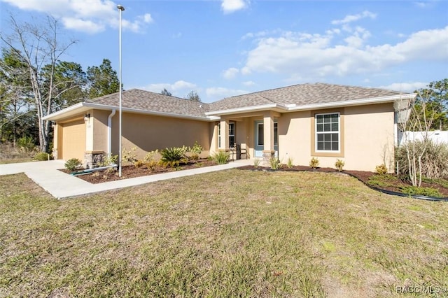 view of front of house with a garage and a front lawn