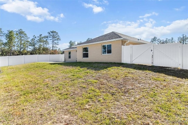 rear view of property with a yard