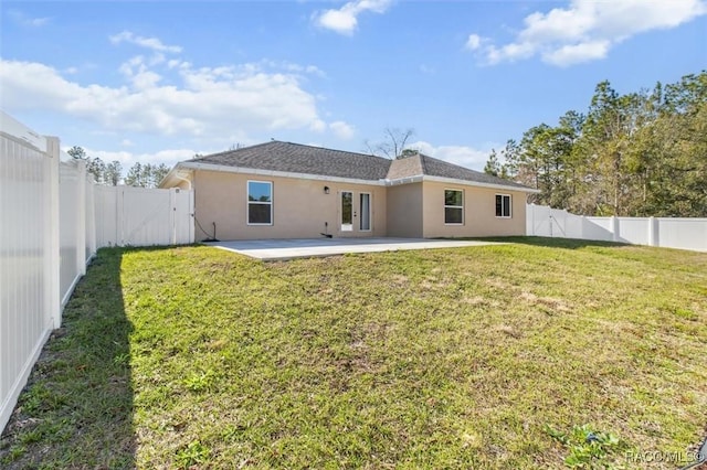 rear view of house featuring a patio and a lawn