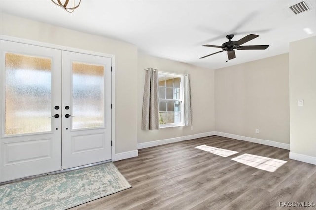 foyer entrance featuring hardwood / wood-style flooring, ceiling fan, and french doors