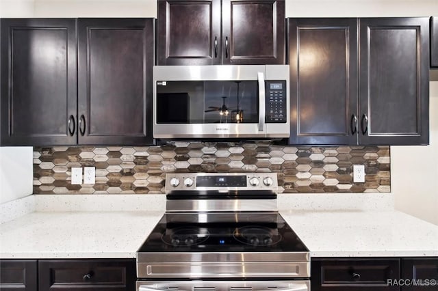 kitchen featuring tasteful backsplash, dark brown cabinetry, and appliances with stainless steel finishes