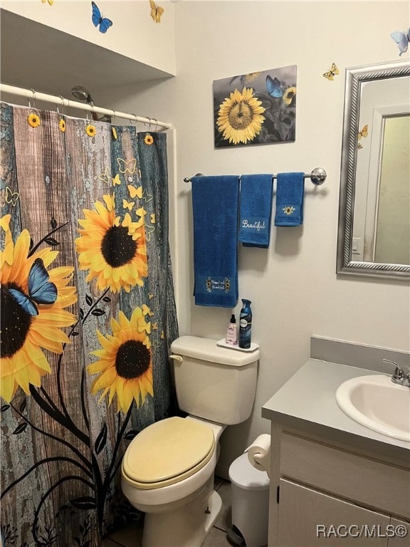 bathroom with tile patterned floors, vanity, and toilet