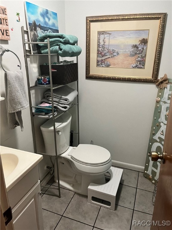 bathroom with tile patterned floors, vanity, and toilet