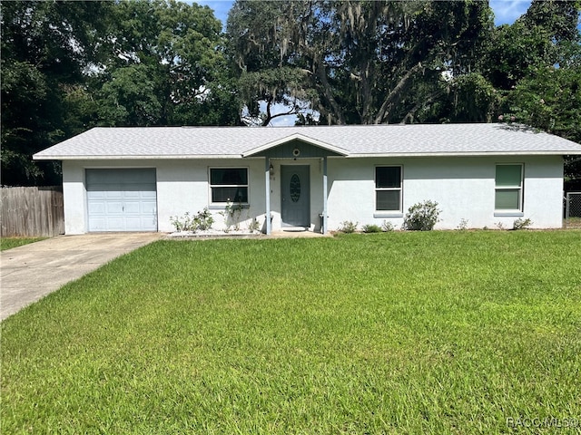 ranch-style home with a garage and a front lawn