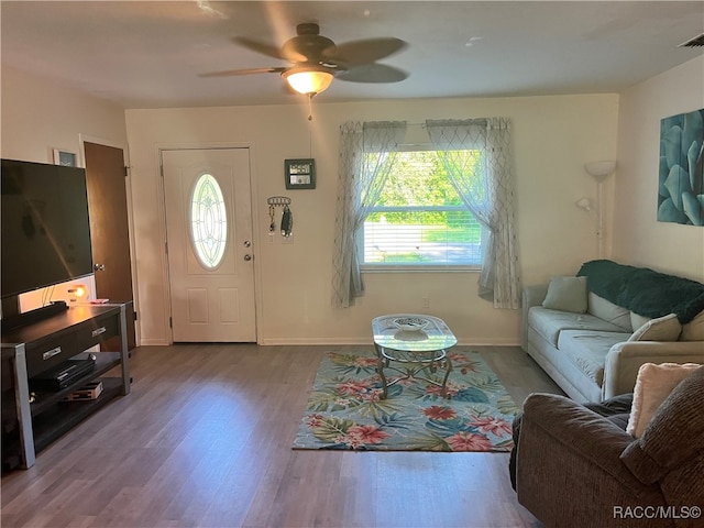 living room with hardwood / wood-style floors and ceiling fan