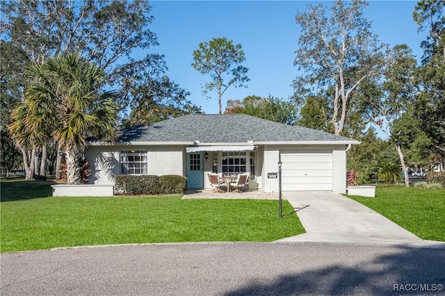 ranch-style house featuring a garage and a front yard