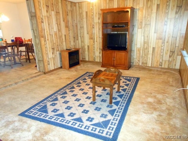 living room featuring wood walls and carpet