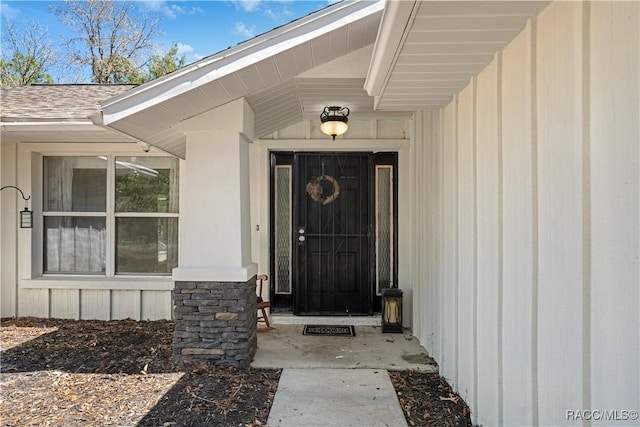 property entrance with a shingled roof