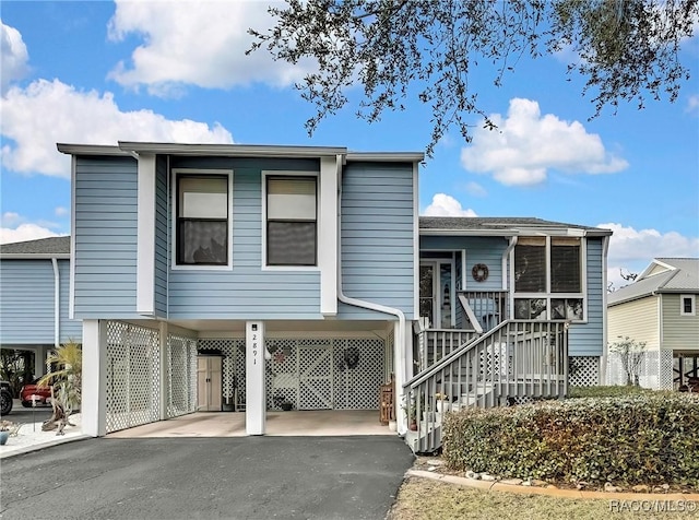 2891 N Rivers Edge Blvd Unit 100, Crystal River, FL 34429 - view of front of home featuring a carport, driveway, and stairway
