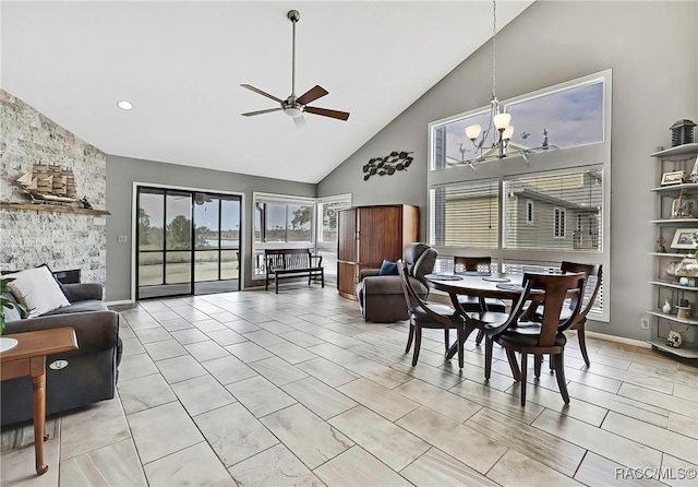 2891 N Rivers Edge Blvd Unit 100, Crystal River, FL 34429 - dining room featuring high vaulted ceiling, a ceiling fan, a chandelier, and baseboards