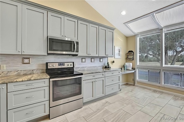 2891 N Rivers Edge Blvd Unit 100, Crystal River, FL 34429 - kitchen with stainless steel appliances, lofted ceiling, gray cabinets, light stone counters, and recessed lighting