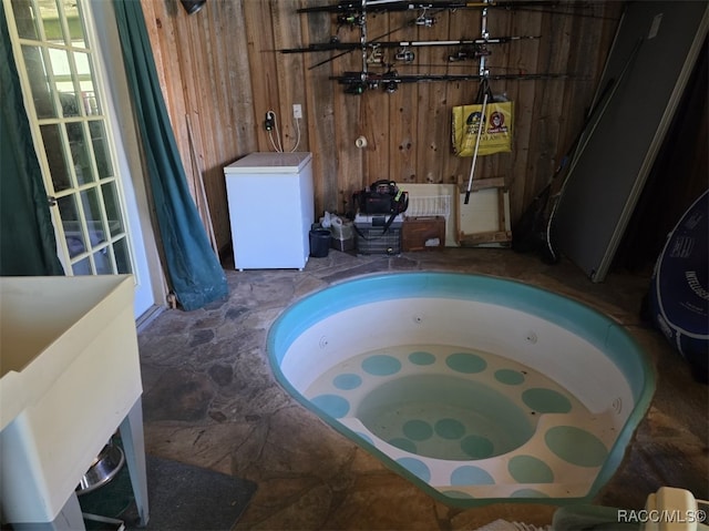 bathroom featuring wooden walls