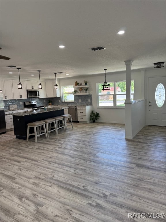 1464 NW 22nd St, Crystal River, FL 34428 - kitchen with appliances with stainless steel finishes, recessed lighting, white cabinets, backsplash, and light wood-style floors
