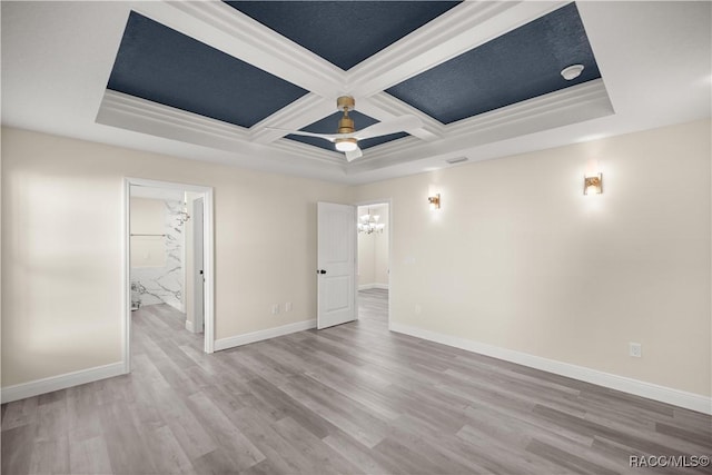 unfurnished room with crown molding, beam ceiling, light hardwood / wood-style flooring, and coffered ceiling