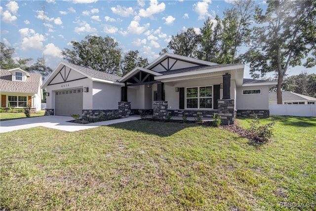 craftsman house with a garage, a front yard, and covered porch