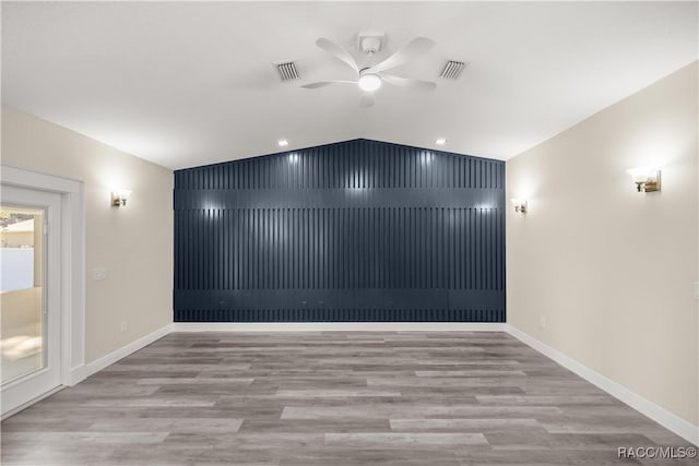 spare room featuring ceiling fan, vaulted ceiling, and light hardwood / wood-style floors