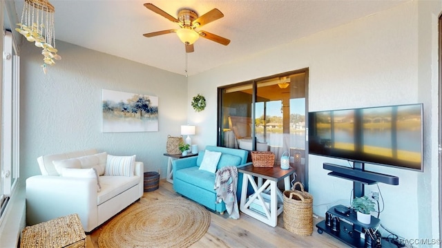 living room featuring hardwood / wood-style flooring and ceiling fan