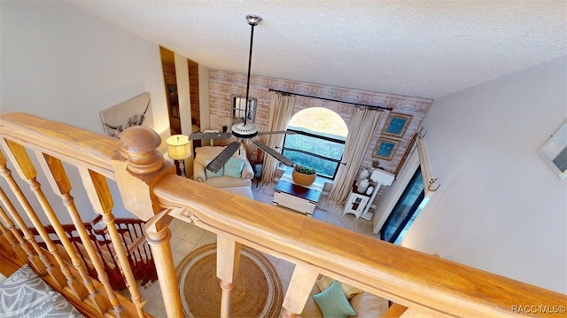 staircase with a textured ceiling