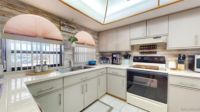 kitchen with sink, tasteful backsplash, white electric stove, tile countertops, and light tile patterned flooring