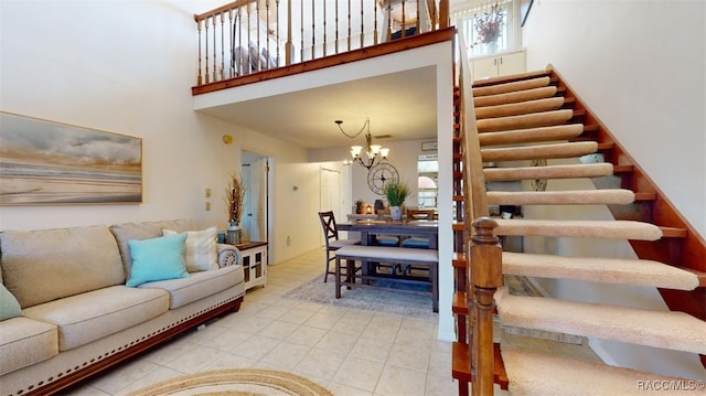 tiled living room with a high ceiling, an inviting chandelier, and stairway