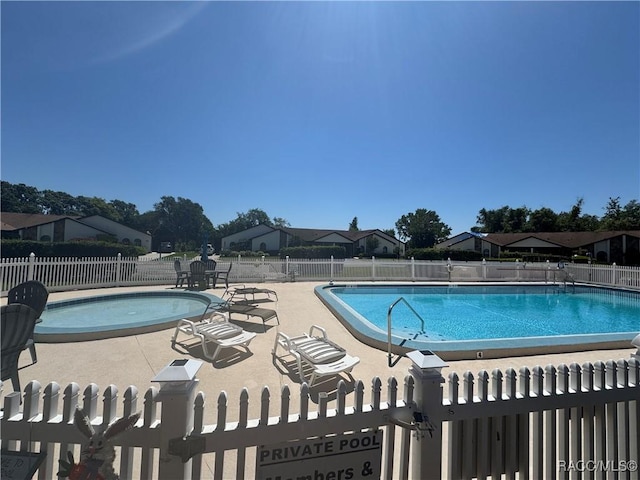 pool featuring fence private yard and a patio