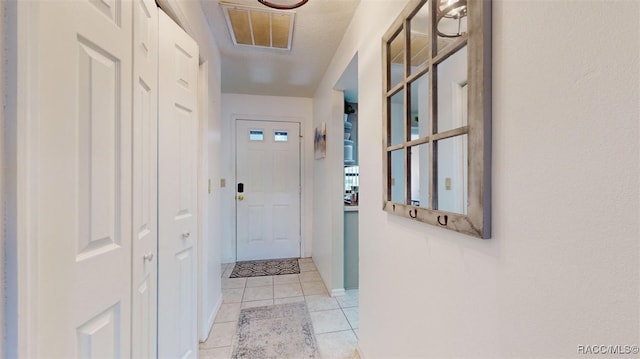 hall with light tile patterned floors