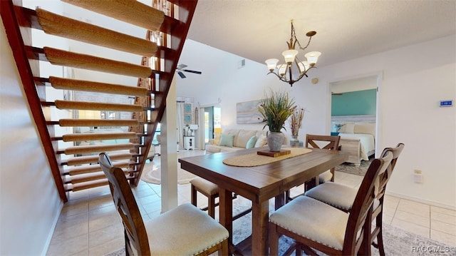 tiled dining area with ceiling fan with notable chandelier