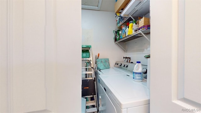 clothes washing area featuring washer and clothes dryer