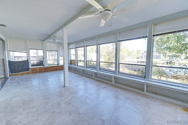 unfurnished sunroom featuring ceiling fan