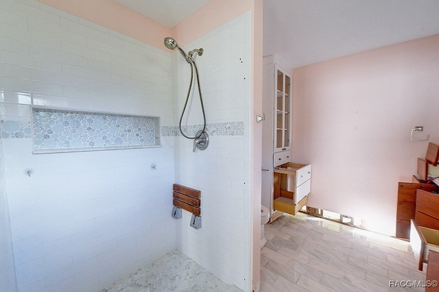 bathroom with a tile shower