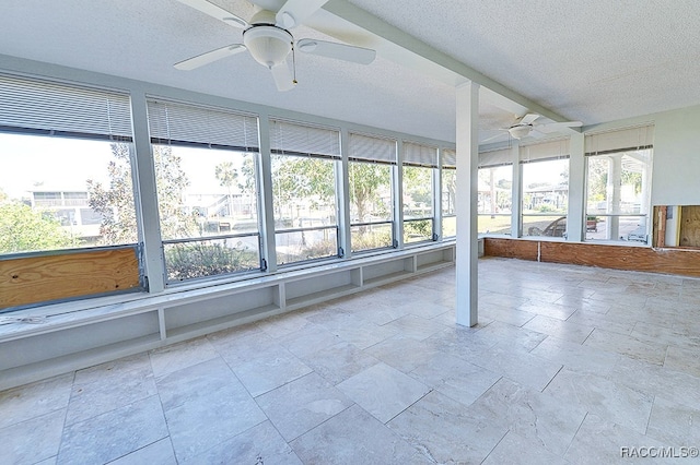 unfurnished sunroom with ceiling fan and a healthy amount of sunlight