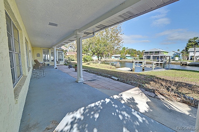 view of patio / terrace with a dock and a water view