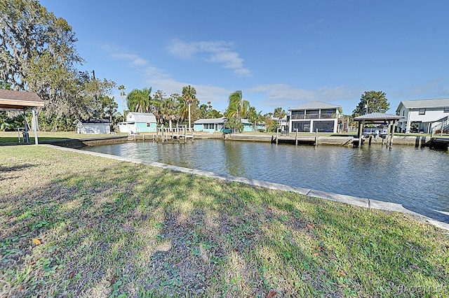 dock area featuring a lawn and a water view