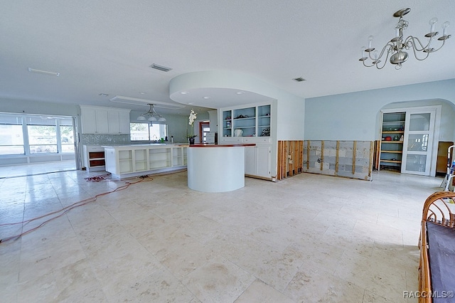 unfurnished living room featuring a textured ceiling